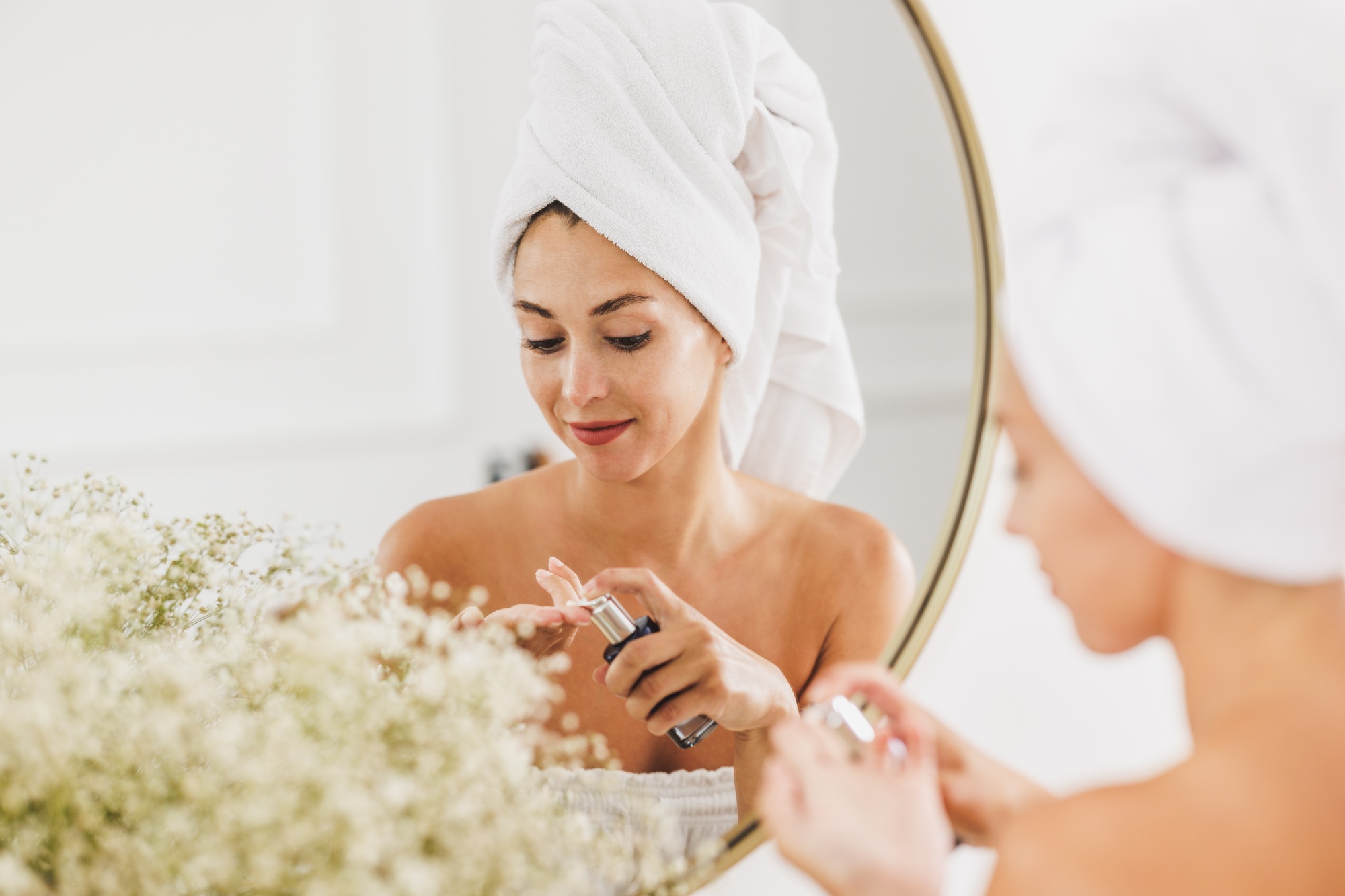 Woman In Front Of Mirror Going Through Her Morning Beauty Routine